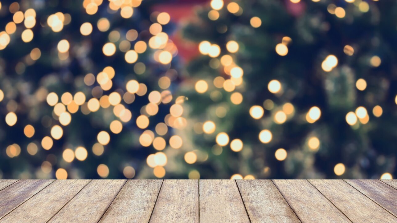 Christmas holiday background with empty wooden table top over festive bokeh light decorate on Christmas tree. For create montage product display